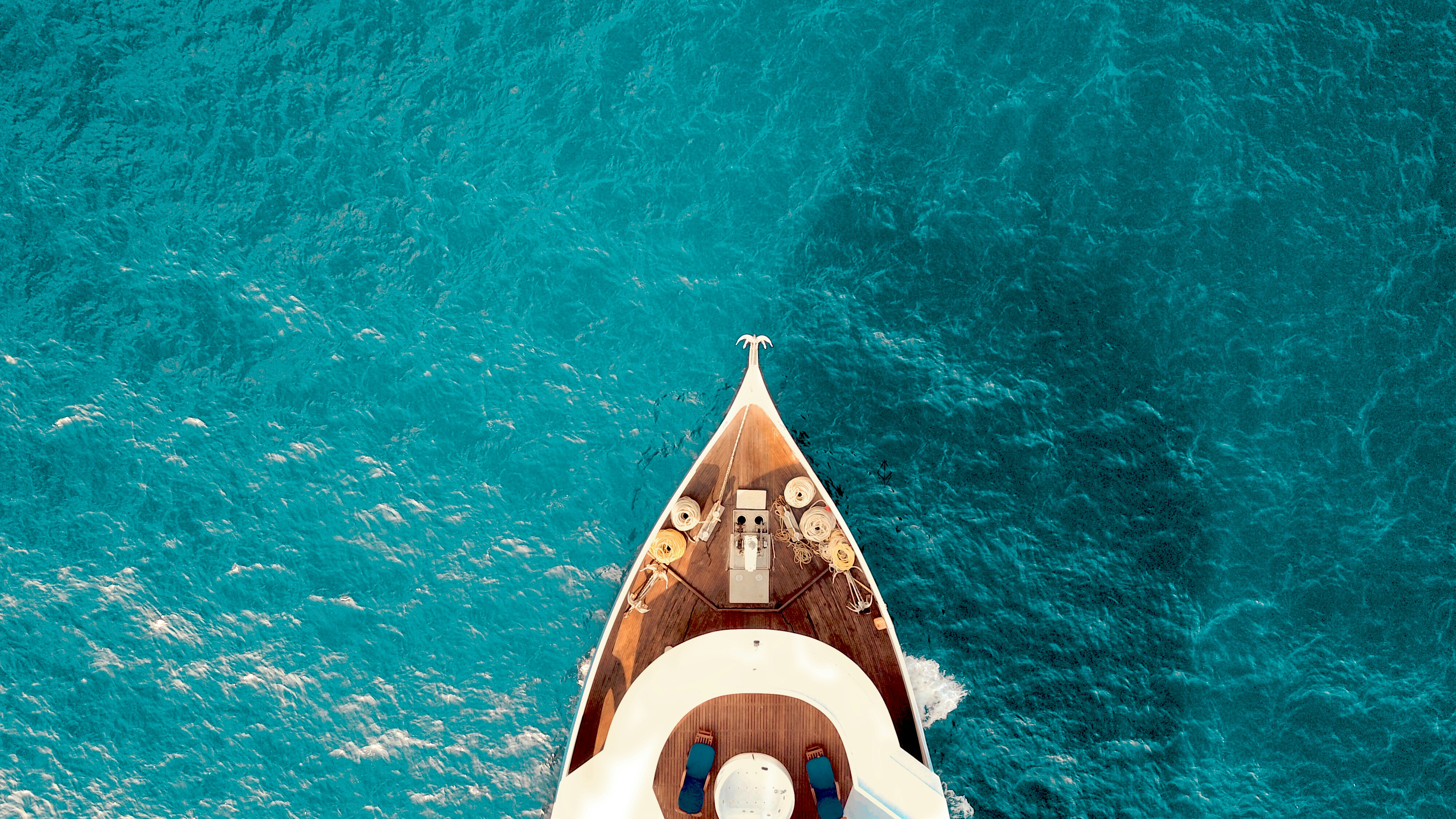 Aerial view of a luxury yacht on turquoise water